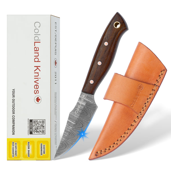 Cold Land Knives knife with wooden handle and leather sheath next to its packaging on a white background